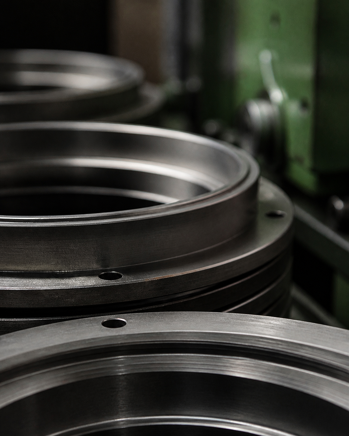 Precision-machined circular steel components in a workshop